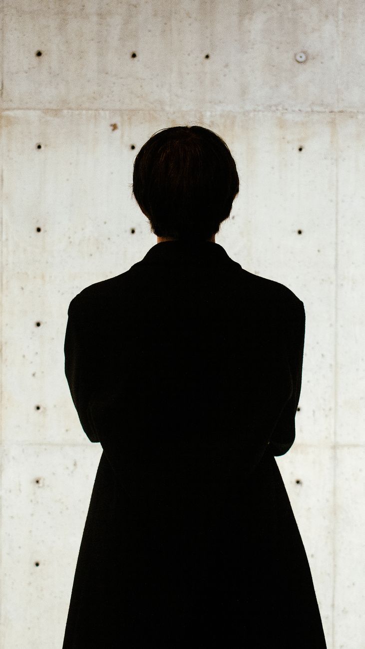 silhouette of a man in a long coat